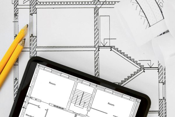 Planning of construction of the house. Tablet, drawings and working tools.